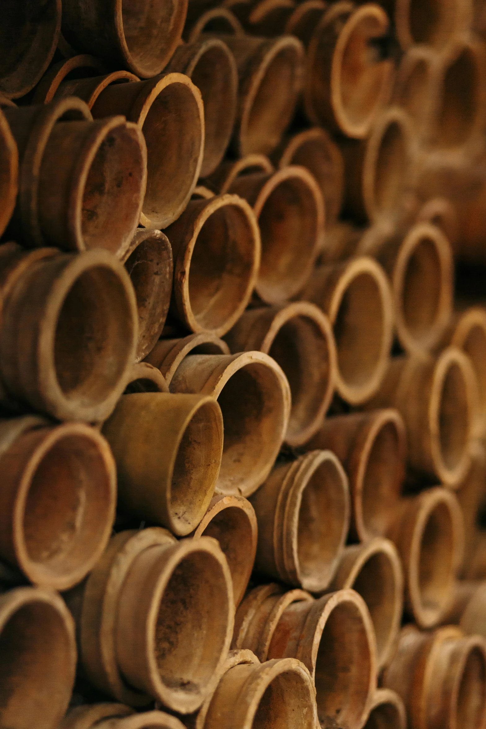 a pile of wooden pipes stacked on top of each other, inspired by Andy Goldsworthy, bottles covered in wax, thumbnail, brown holes, close up photo