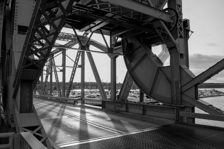 a black and white photo of a bridge, a black and white photo, by Dave Melvin, mechanical superstructure, afternoon sunlight, memphis, detailed medium format photo