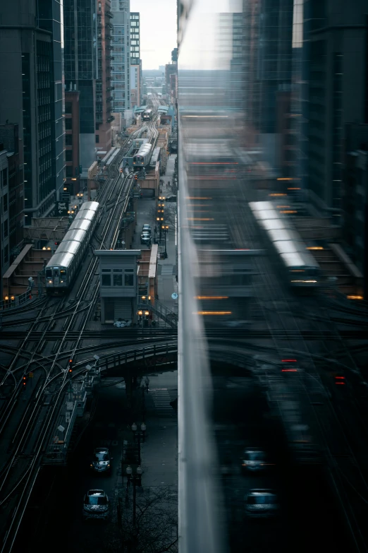 a train traveling through a city next to tall buildings, by Dan Christensen, unsplash contest winner, motion lines, chicago, zoomed in shots, early evening