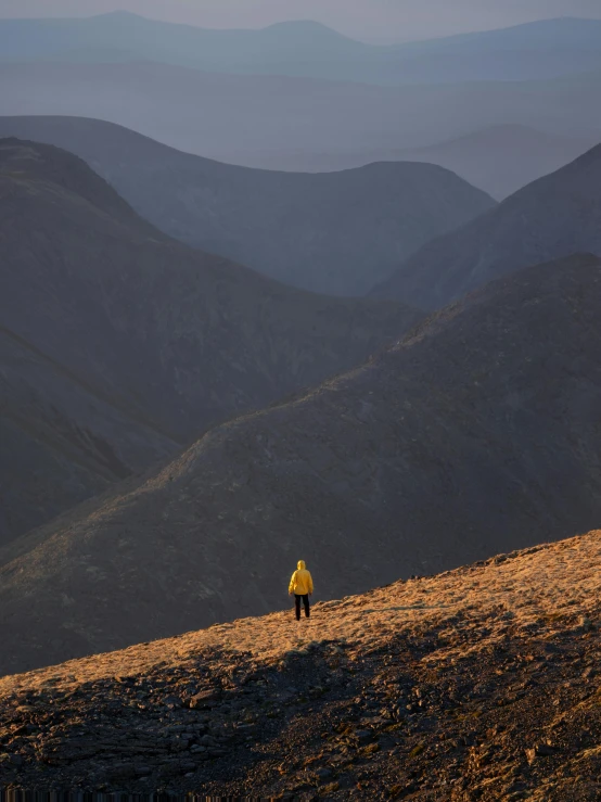 there is a person standing at the top of this hill