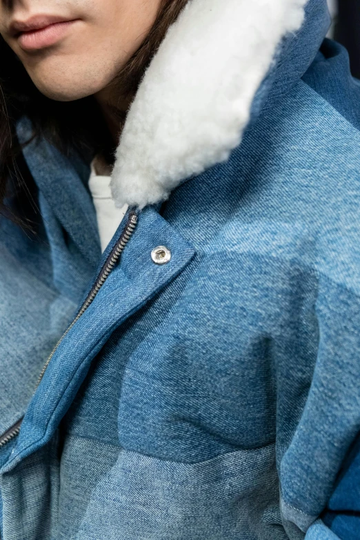 a woman is wearing an oversize denim jacket with a sherpot