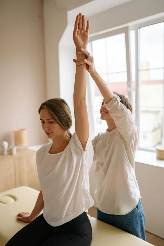 two women doing stretching exercises in a room, trending on pexels, renaissance, wearing a light shirt, comforting, square, standing up