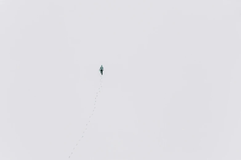 a person is flying a kite in the sky, by Attila Meszlenyi, postminimalism, walking on ice, the sky is gray, fear of heights, listing image