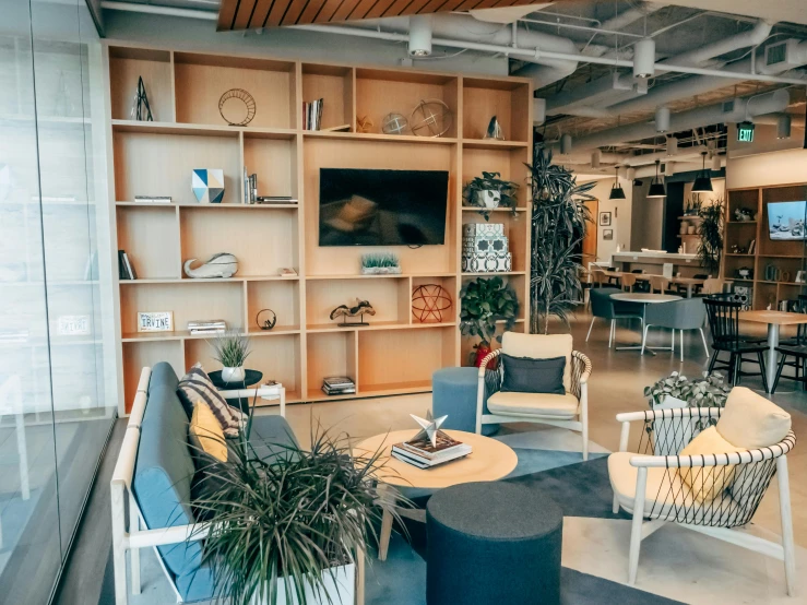 an office is empty with wooden shelves, chairs and television