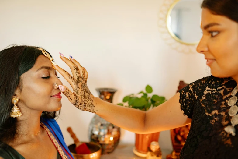 the woman is getting her make up done at her wedding