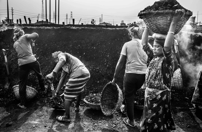 a group of people that are standing in the dirt, a black and white photo, pexels contest winner, process art, smelters, womanhood”, photography from vogue magazine, people at work