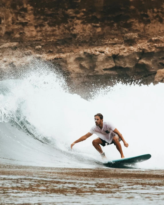 a man riding a wave on top of a surfboard, pexels contest winner, tan skin a tee shirt and shorts, thumbnail, lgbtq, best photo