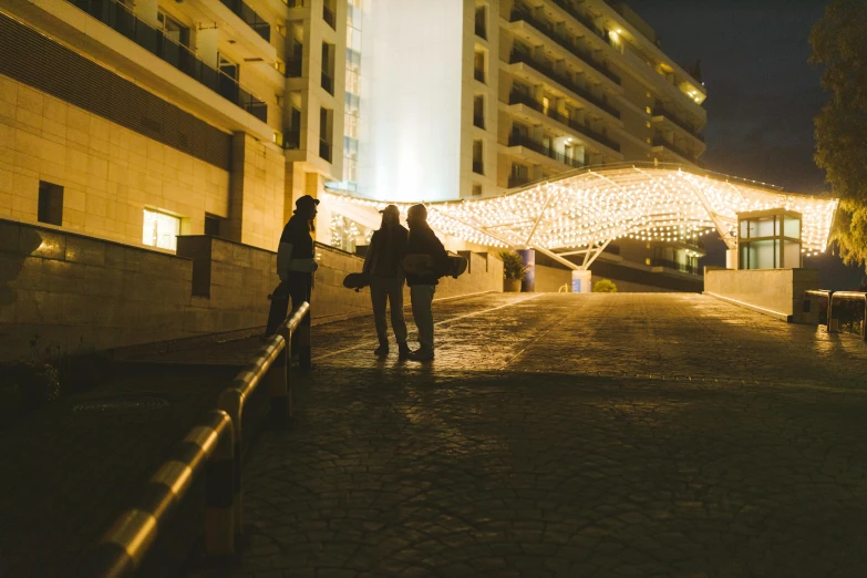 a couple of people walking down a street