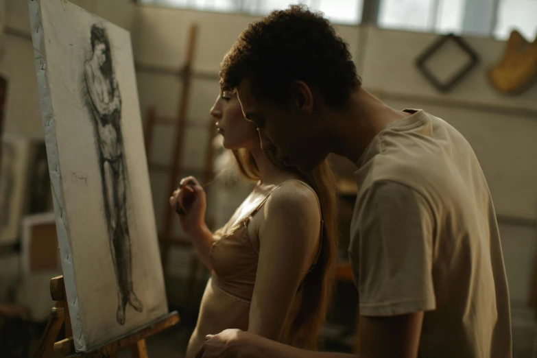 a man and a woman standing in front of a painting, pexels contest winner, figurative art, life drawing, studious chiaroscuro, making love, easel