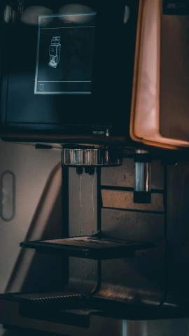 a coffee machine sitting on top of a counter, by Jacob Toorenvliet, unsplash contest winner, modernism, 8 k detail, thumbnail, low quality photo, vhs footage of a movie set