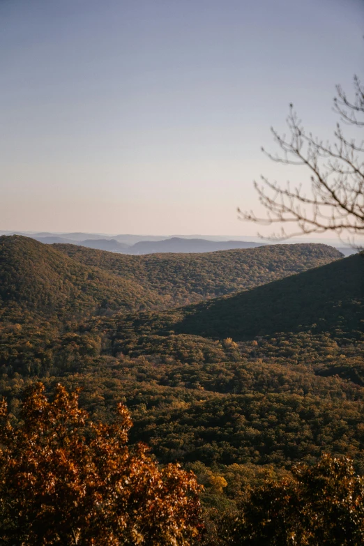 a view of the mountains from the top of a hill, a picture, inspired by Elsa Bleda, trending on unsplash, hudson river school, william penn state forest, high angle view, dappled in evening light, mid fall