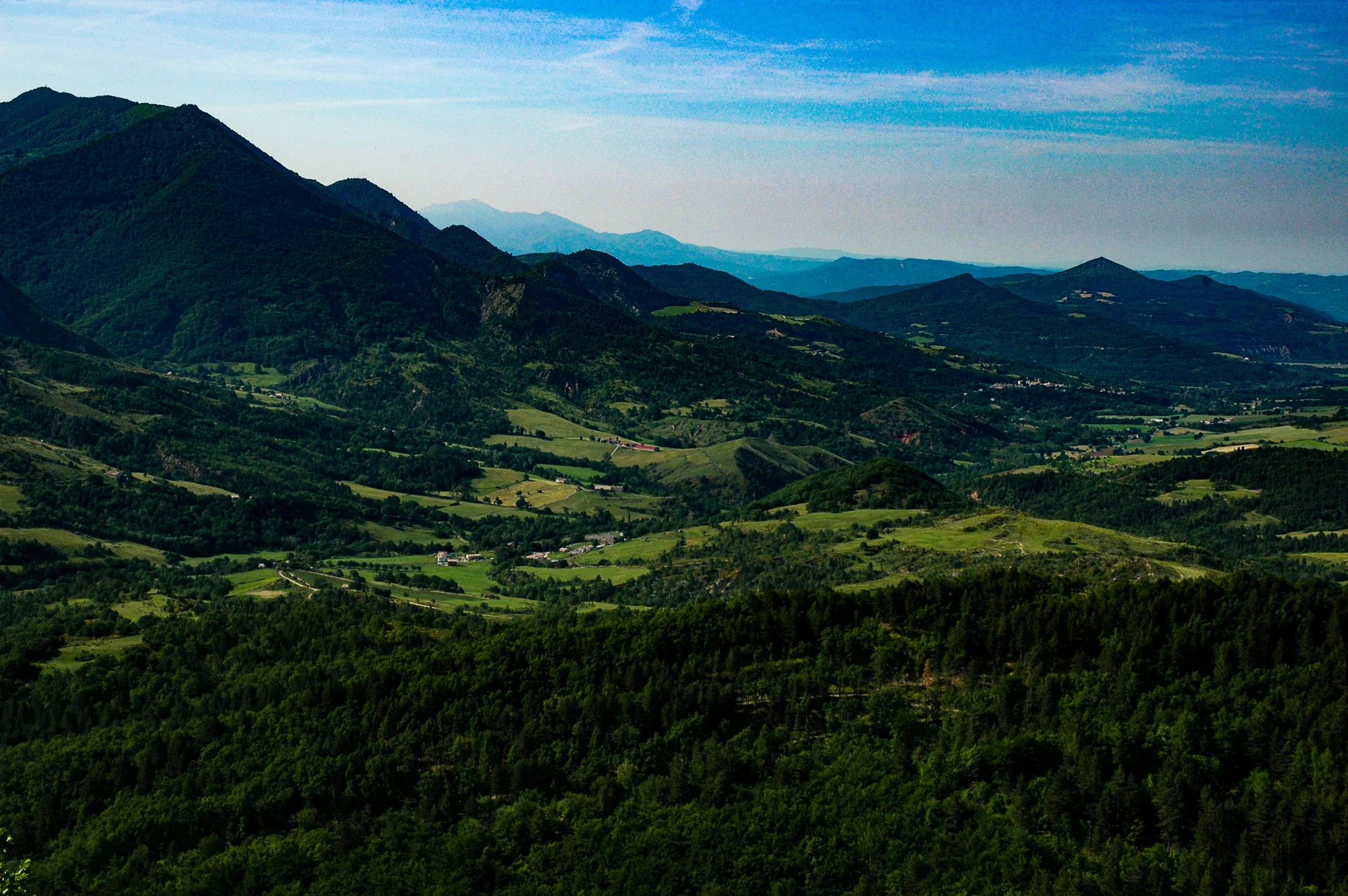 a hill side view with trees on both sides