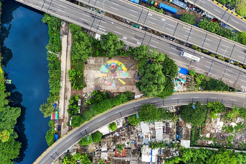 an aerial view of a city with lots of traffic, by Daniel Lieske, street art, wall with colorful graffiti, manila, 2 0 2 2 photo, a park