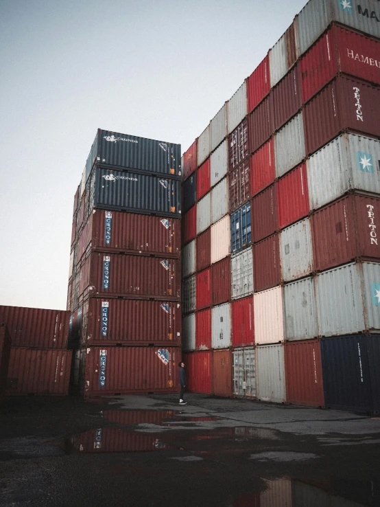 a bunch of containers stacked on top of each other, an album cover, unsplash, ignant, shipyard, video footage, 90s photo