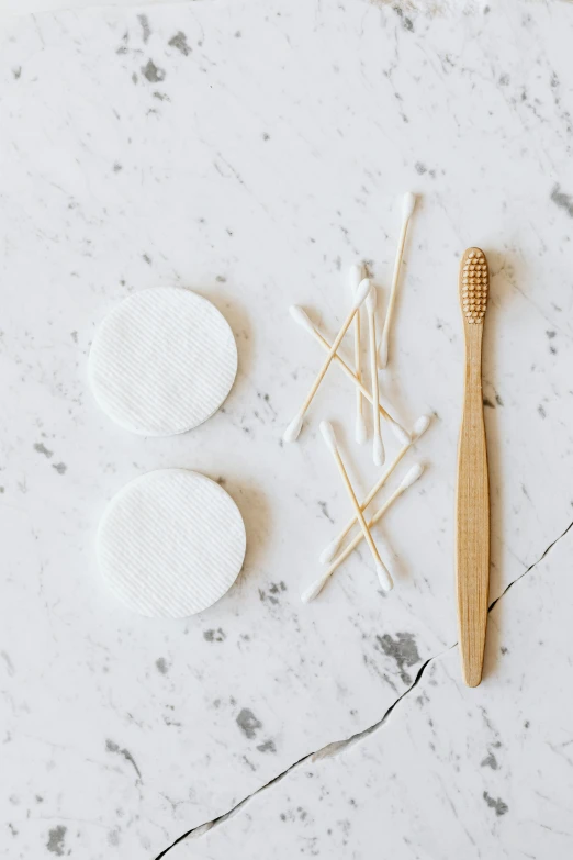 a wooden toothbrush sitting on top of a marble counter, unsplash, knolling, tiny sticks, made of lab tissue, sleek round shapes