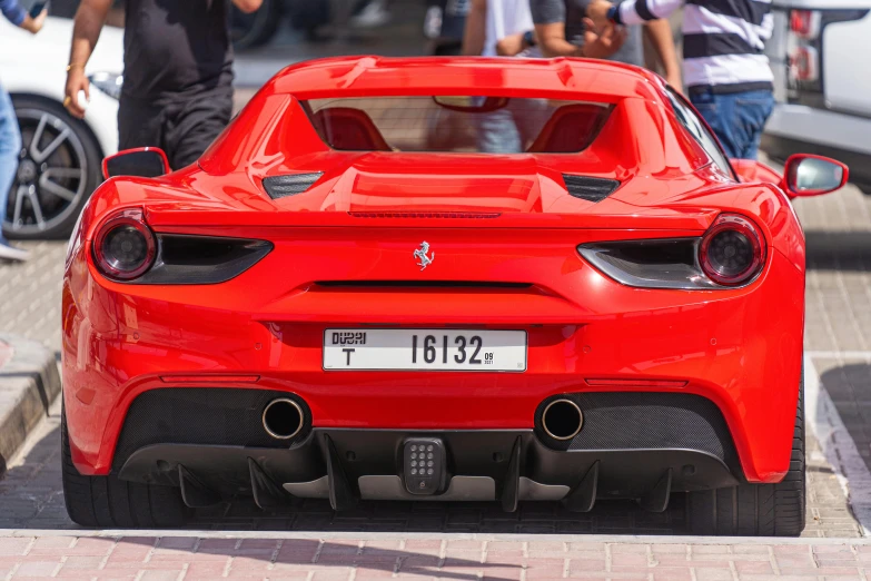 a red sports car parked on the side of the road, pexels contest winner, hyperrealism, dubai, f12, back, high gloss