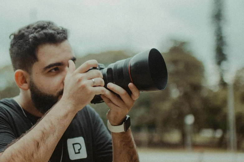 a man taking a picture with a camera, pexels contest winner, photorealism, 4 0 0 mm lens, low quality photo, professional profile picture, holding a big camera