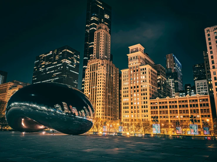 some very tall buildings and some lights at night