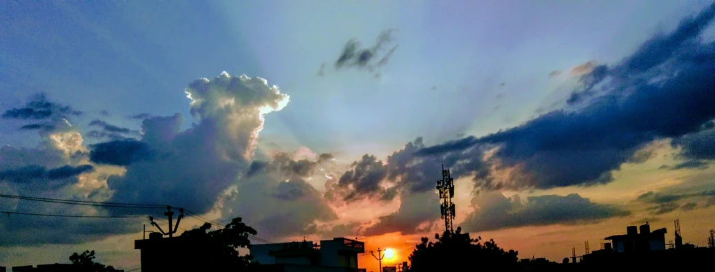 the sun is setting behind the clouds in the sky, a picture, by Sudip Roy, pexels contest winner, realism, cell phone photo, ☁🌪🌙👩🏾, very colorful heavenly, journalism photo