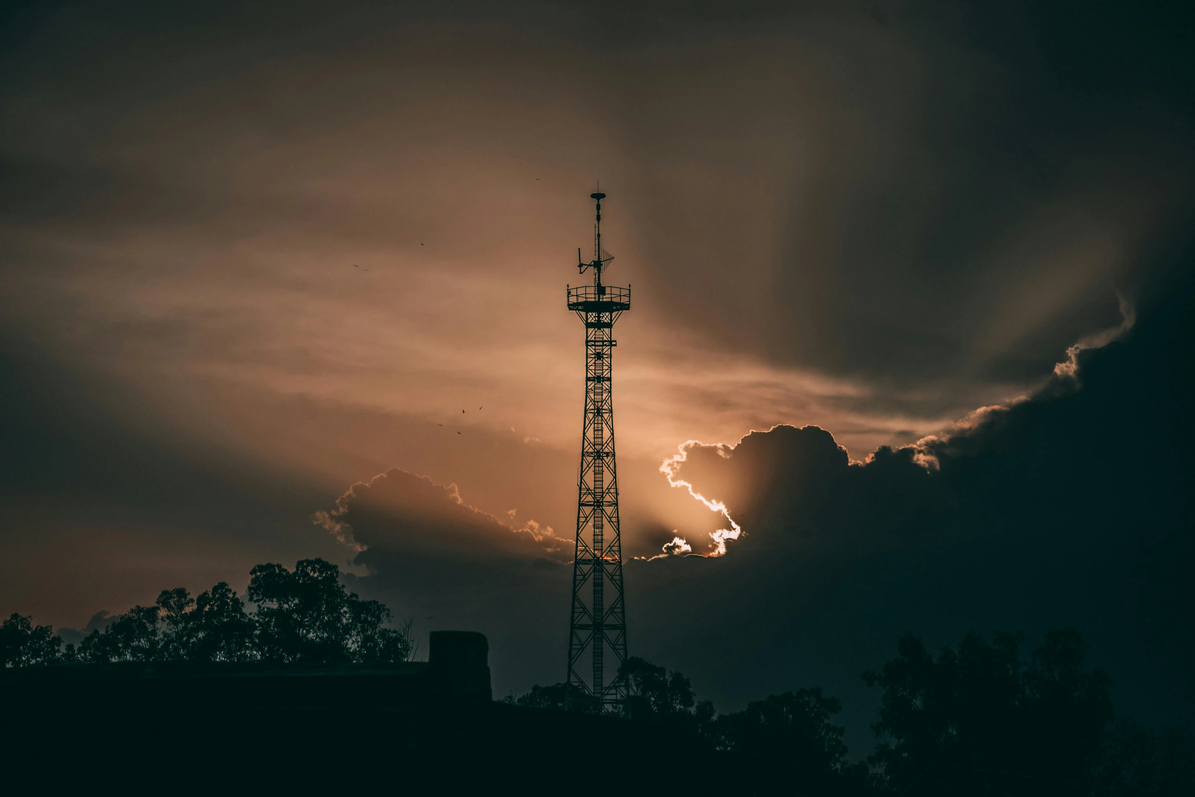 a tall tower sitting on top of a lush green field, unsplash, australian tonalism, radio signals, dramatic storm sunset, 90s photo, instagram photo