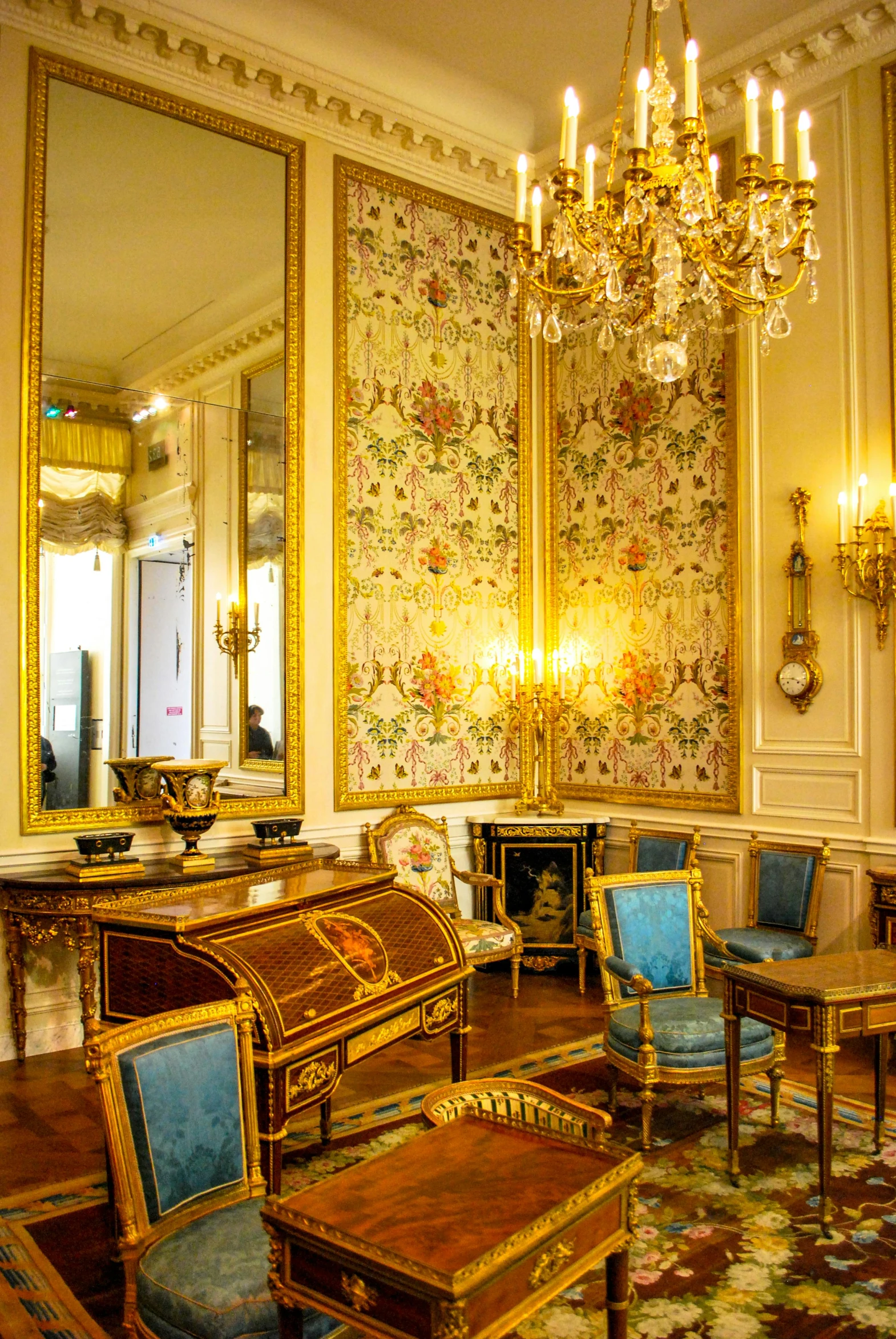 an ornate living room with tables and couches