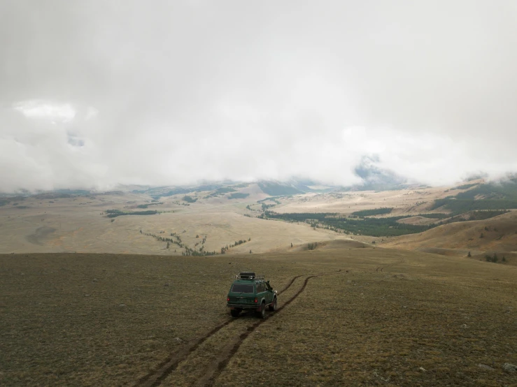 a truck that is sitting in the middle of a field, by Daren Bader, unsplash contest winner, visual art, tengri, high above treeline, distant full body view, moskvich