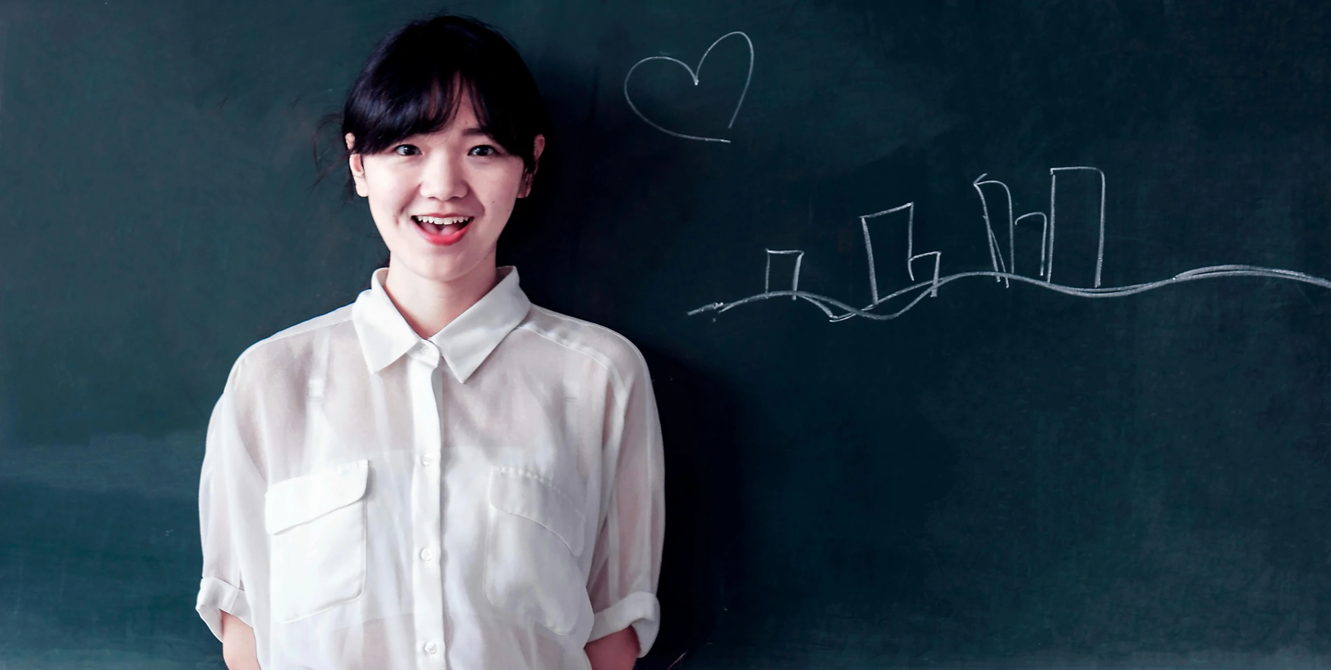 a woman standing in front of a blackboard, inspired by Ma Yuanyu, pexels contest winner, smiling sweetly, south korean male, hearts, 15081959 21121991 01012000 4k