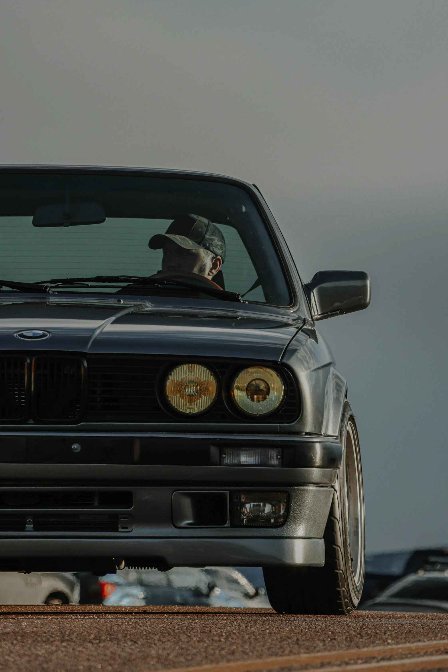 a car that is sitting on the side of the road, a portrait, unsplash, renaissance, bmw e 3 0, visor covering eyes, old male, profile image