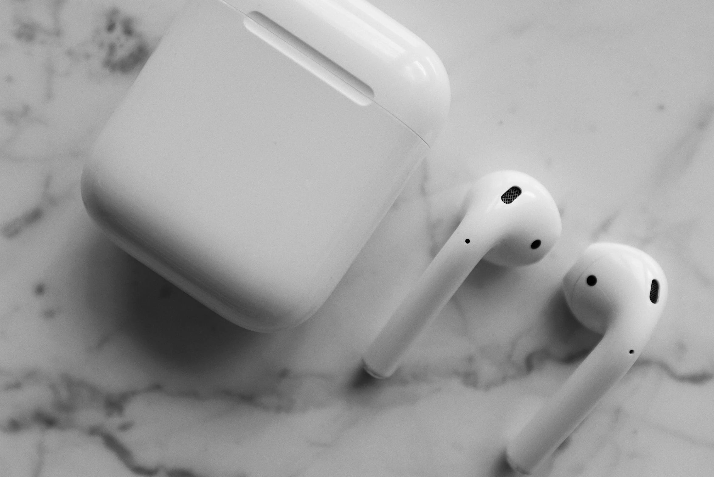 a pair of airpods sitting on top of a marble counter, a black and white photo, trending on pexels, white monochrome color!!!!!, apples, birds eye, square