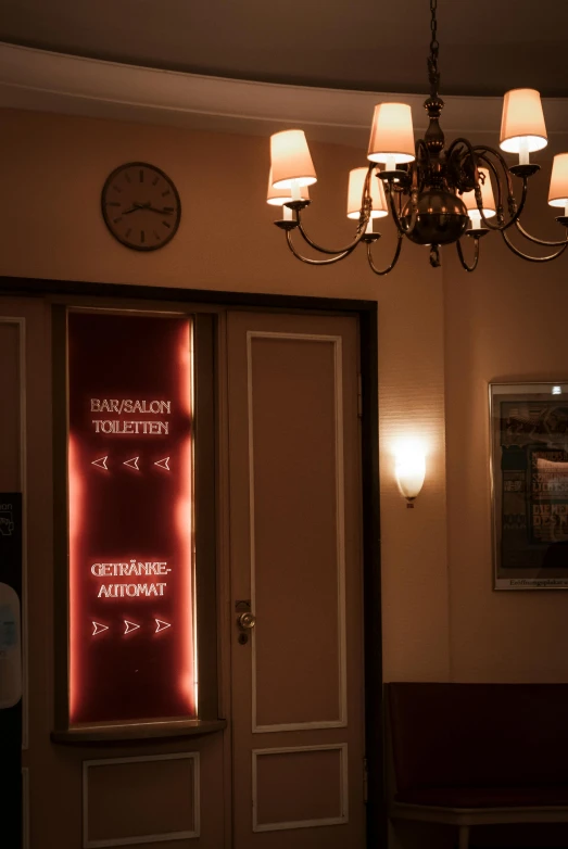 a lit sign with red lights in a room