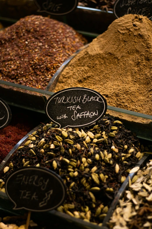 a display case filled with lots of different types of spices, a picture, by Julia Pishtar, hurufiyya, with black, detail shot, black sokkel, coffee