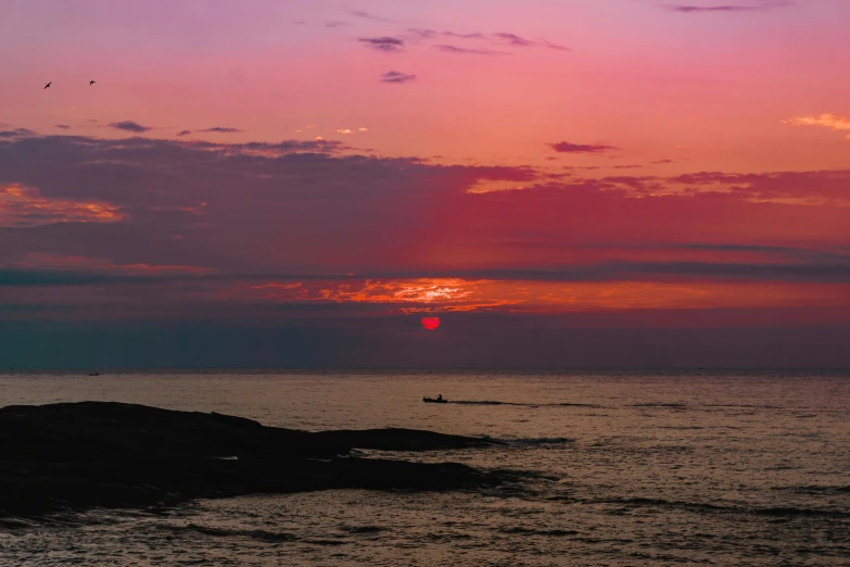 a large body of water with a sunset in the background, by Alison Watt, pexels contest winner, pink hues, marsden, red horizon, manly