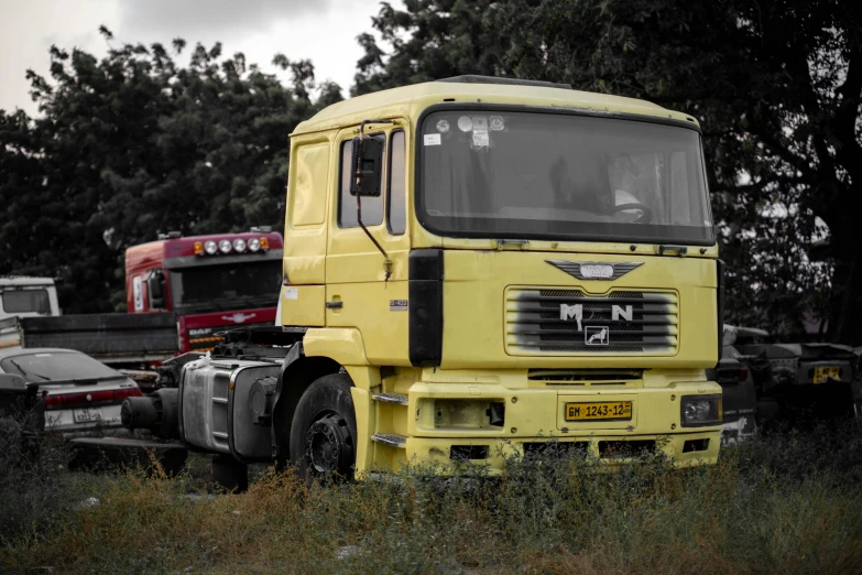 a yellow truck that is sitting in the grass, a portrait, unsplash, india, 1990's photo, 15081959 21121991 01012000 4k, maintenance photo