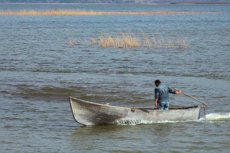 a man in a boat on a body of water, by Alexander Runciman, pexels contest winner, hurufiyya, skiff, artisanal art, thumbnail, grey