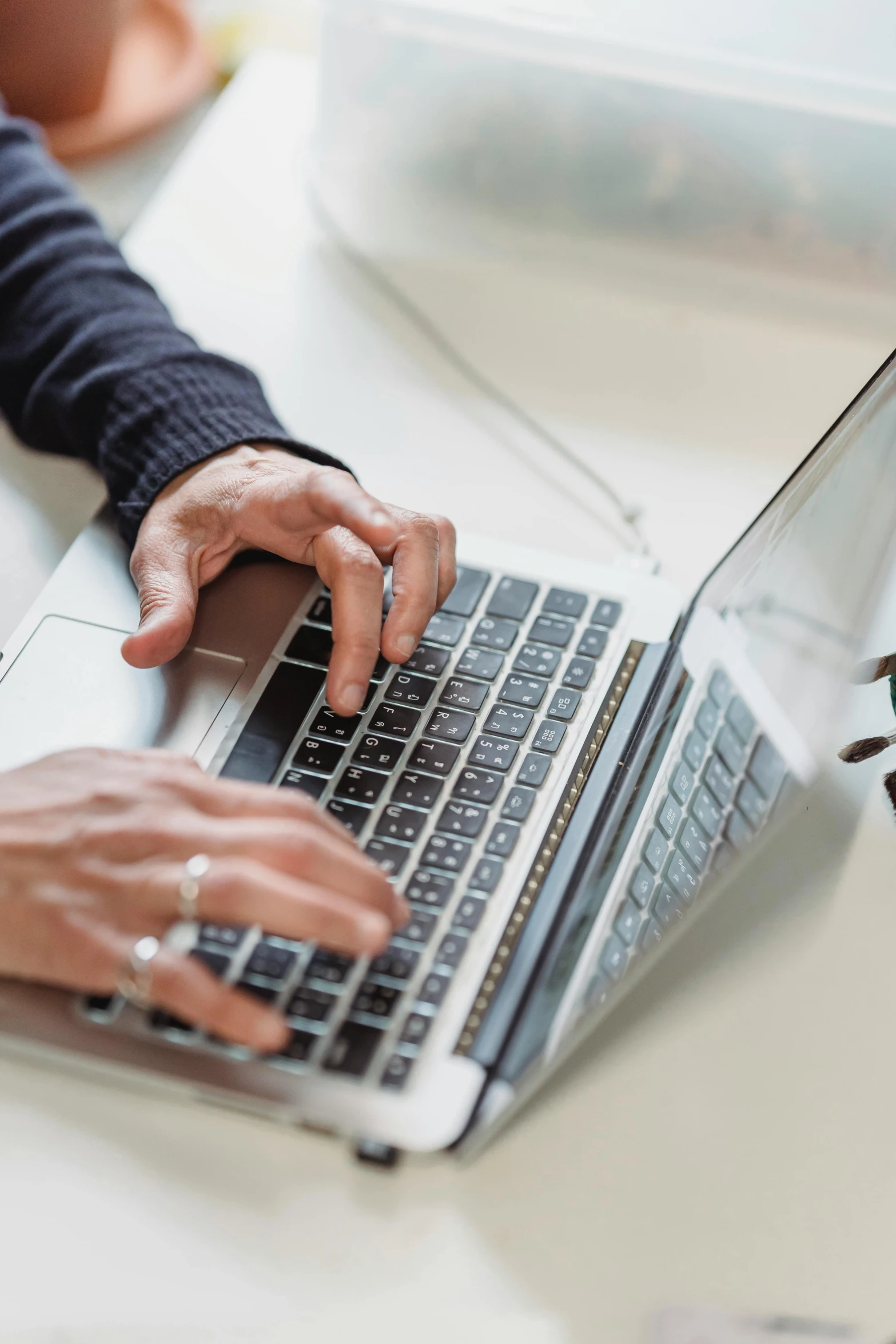 a close up of a person typing on a laptop, by Carey Morris, trending on, digital image, multiple stories, full-body