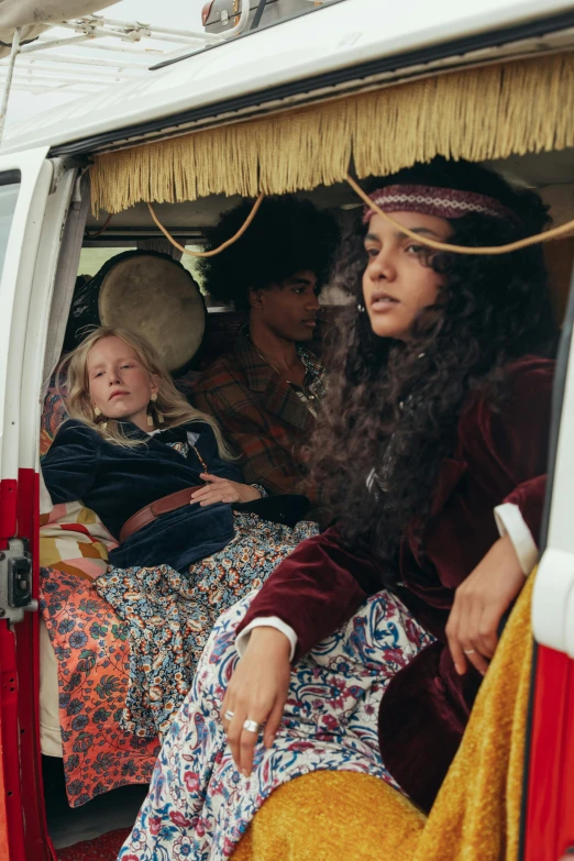 a group of people sitting in the back of a van, by Winona Nelson, renaissance, sleeping, imaan hammam, fancy dress, woodstock