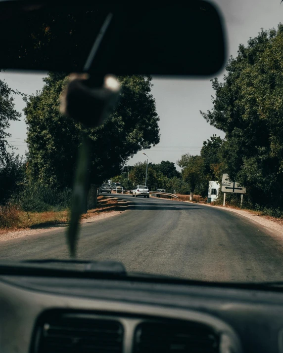 a view of a road through the windshield of a car, by Carey Morris, pexels contest winner, realism, instagram story, small town surrounding, low quality photo, thumbnail