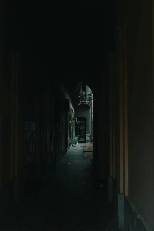 a dark hallway with a light at the end of it, a picture, inspired by Elsa Bleda, old jeddah city alley, low quality photo, cinematic shot ar 9:16 -n 6 -g, wide film still
