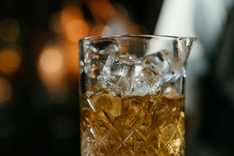 a glass filled with ice sitting on top of a table, a portrait, unsplash, renaissance, whisky, close-up photo, brown, a blond