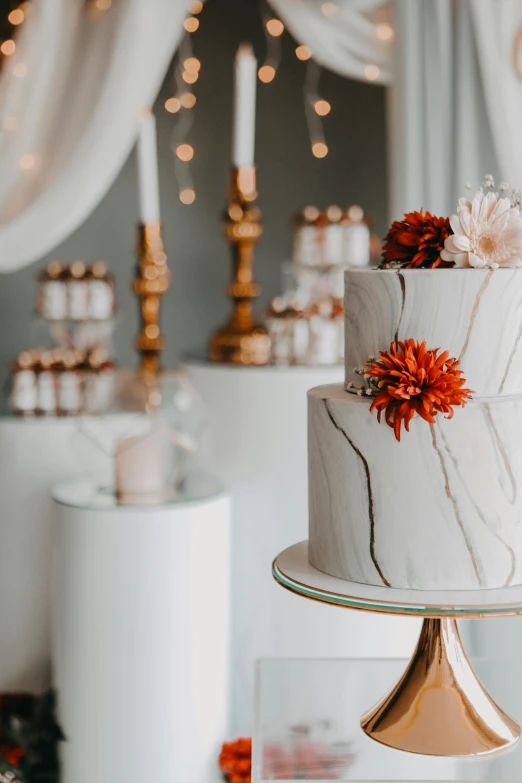 a white cake with pink flowers sitting on a table