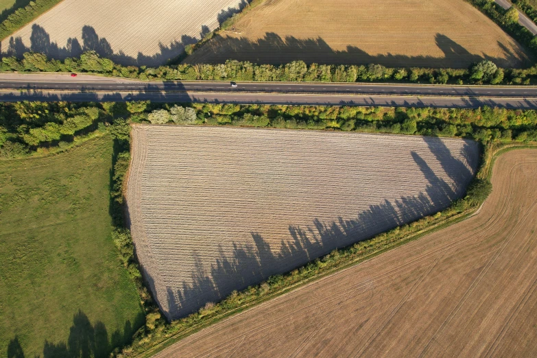 aerial view of two road and field near intersection