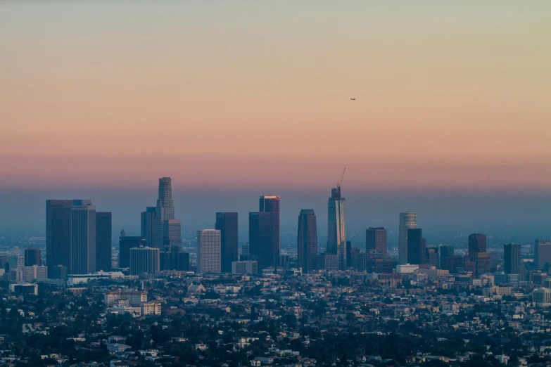 a view of a city from the top of a hill, a photo, inspired by L. A. Ring, unsplash contest winner, in a sunset haze, 2 0 2 2 photo, low detail, twilight skyline