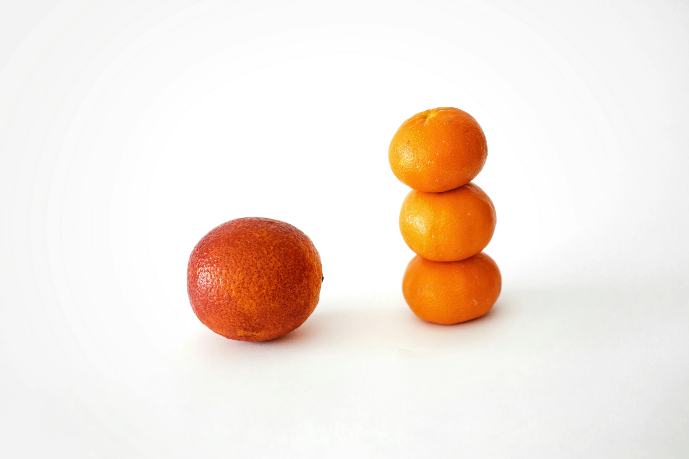 a stack of three oranges next to an orange, inspired by Sarah Lucas, tall and slim figured, kimagure orange road, high quality product photo, various sizes