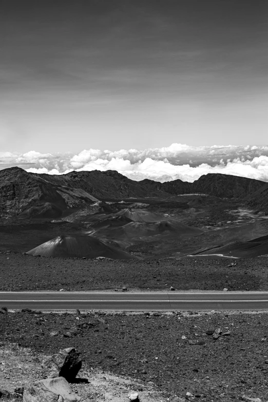 a landscape with mountains and some clouds in the distance