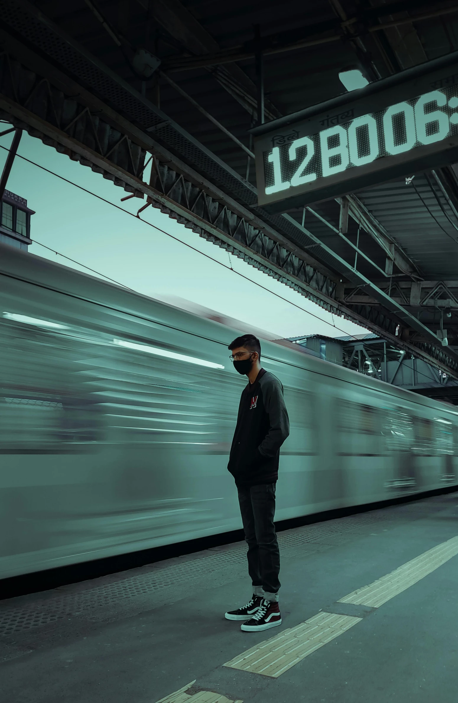 a man standing in front of a train at a train station, an album cover, pexels contest winner, wearing facemask, trending on artstattion, profile pic, deep in thought