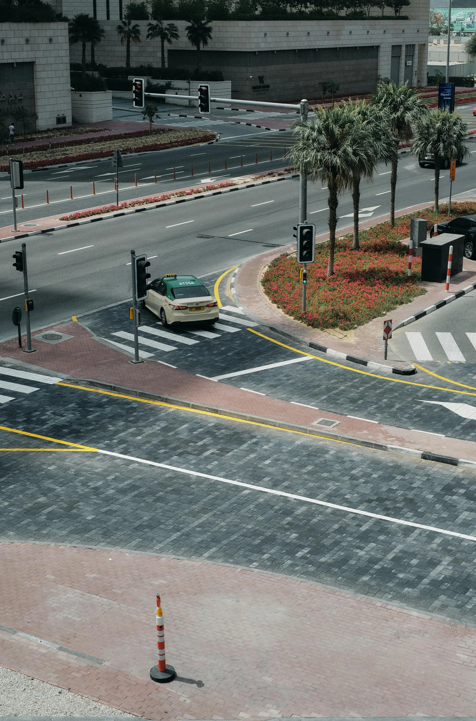 a person in a red jacket is standing on the sidewalk