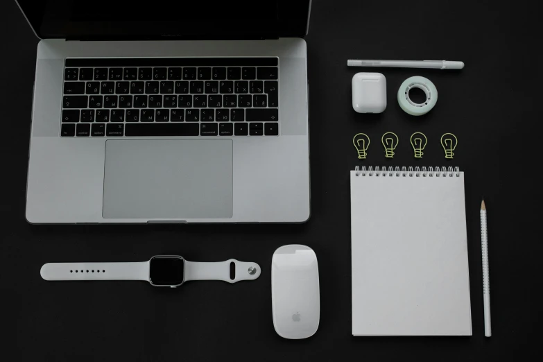 an open laptop computer sitting on top of a desk, pexels, minimalism, on black paper, knolling, white mouse technomage, apple design