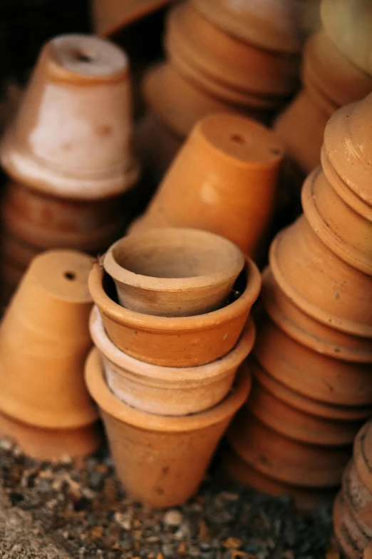 a pile of clay pots sitting next to each other, cone shaped, organized, petite, precision