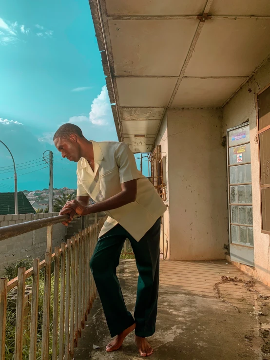 an older man standing on the rail of an outdoor building