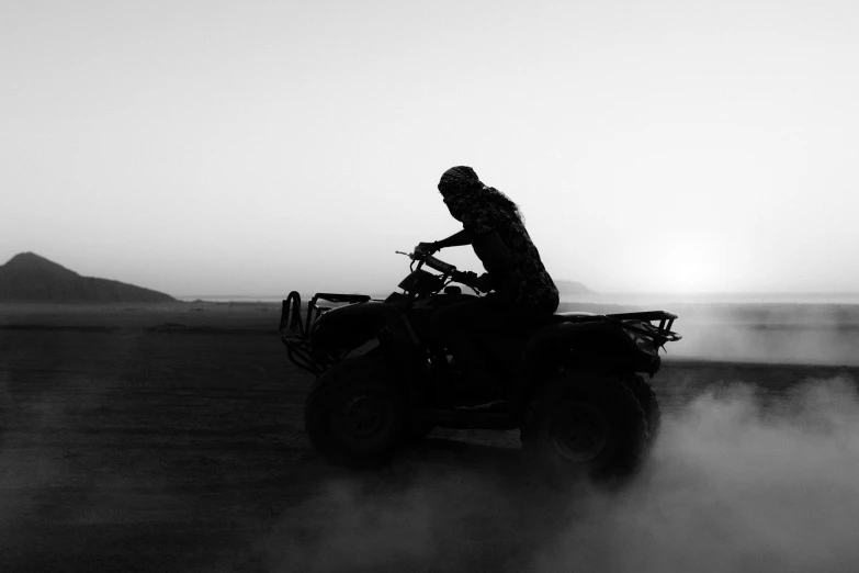a person riding on an atv in the middle of a desert